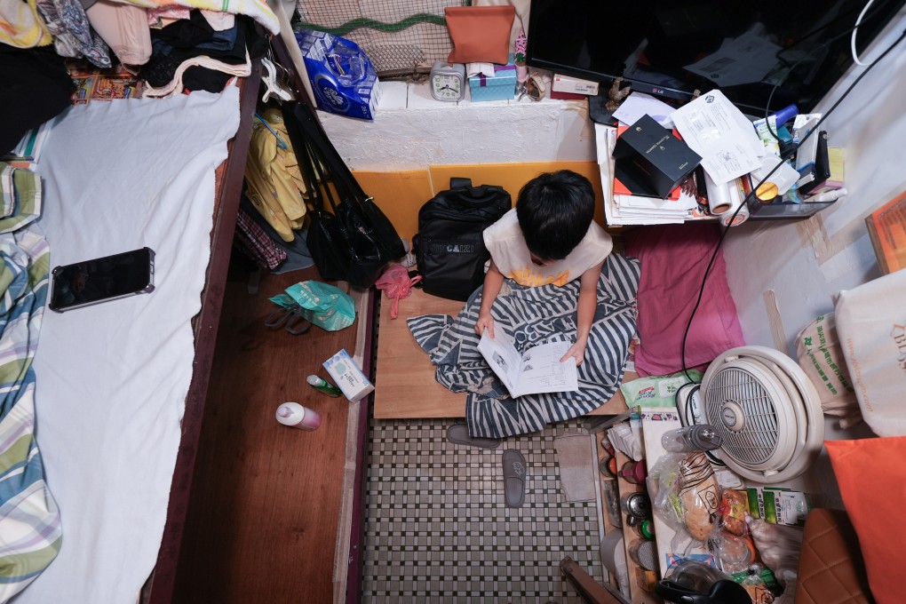 A boy does homework in a subdivided flat in Sham Shui Po after moving to Hong Kong from Guangdong province. Photo: Eugene Lee