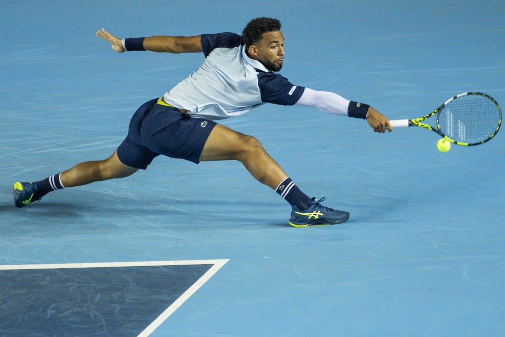 Arthur Fils slides to reach a backhand in his Bank of China Hong Kong Open victory over Zizou Bergs. Photo: Getty Images