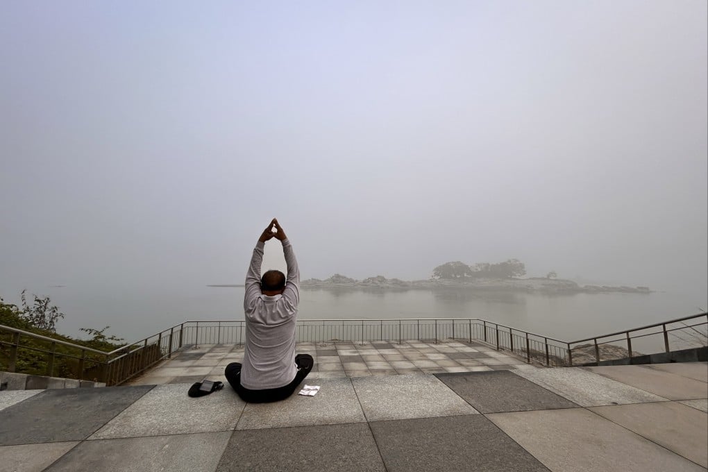 A man performs yoga on the banks of the Brahmaputra in Guwahati, India, on December 7. The river is central to the socioeconomic development of both India and China. Photo: AP