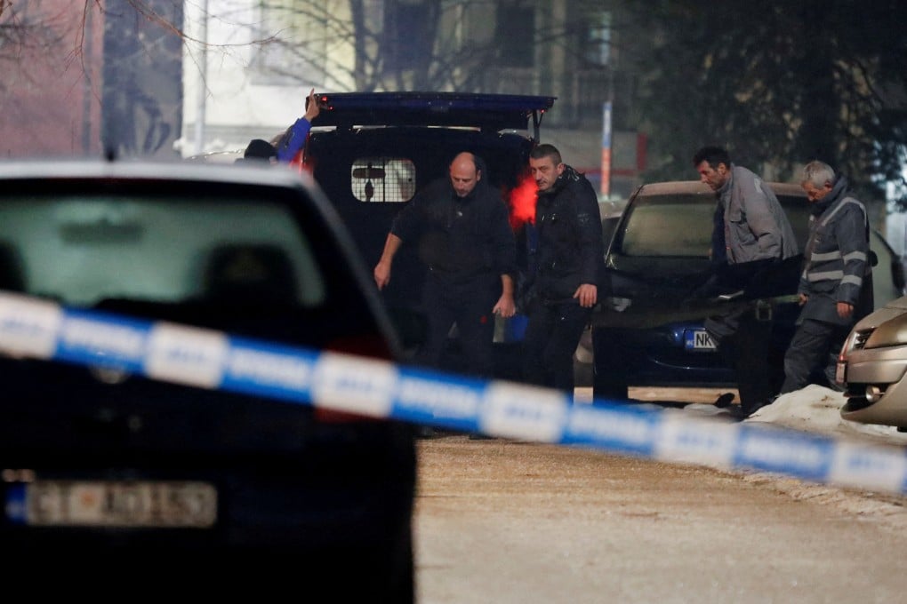 Workers carry a body after a gunman opened fire and killed several people in Cetinje, Montenegro. Photo: Reuters