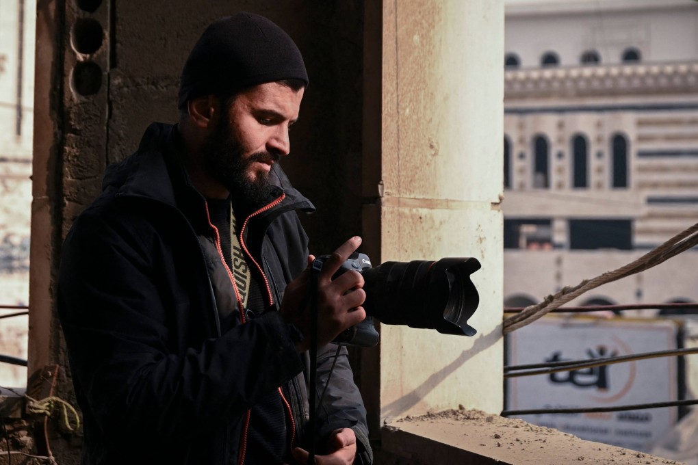 France-based photojournalist Sameer al-Doumy photographs Douma from a damaged building. He says returning to his Syrian hometown doesn’t offer comfort. Photo: AFP