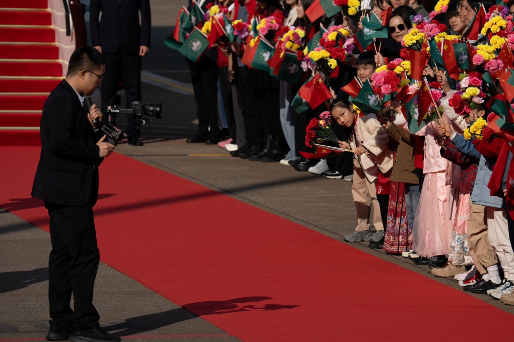 Children wave flags of Macau and China before the departure of President Xi Jinping at Macau International Airport on December 20. Photo: Reuters