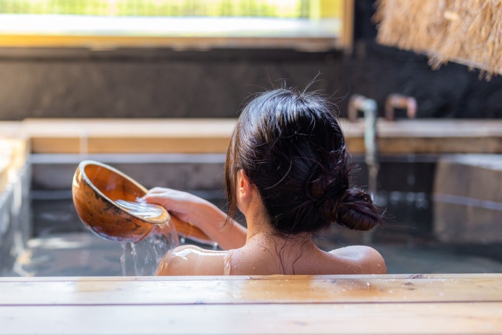 A woman enjoys a hot bath at an onsen resort in Japan. Photo: Shutterstock