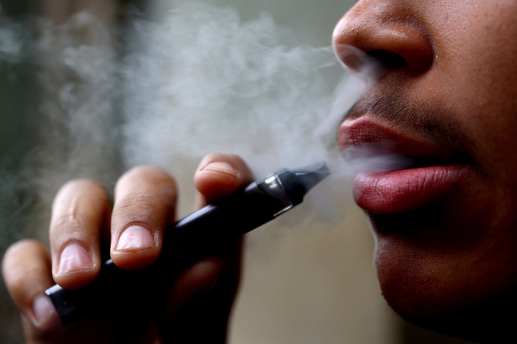 A man smokes a disposable vape. Tourists caught vaping in Vietnam face a fine, while those found selling the e-cigarettes face much bigger fines and jail terms of up to 15 years. Photo: Reuters