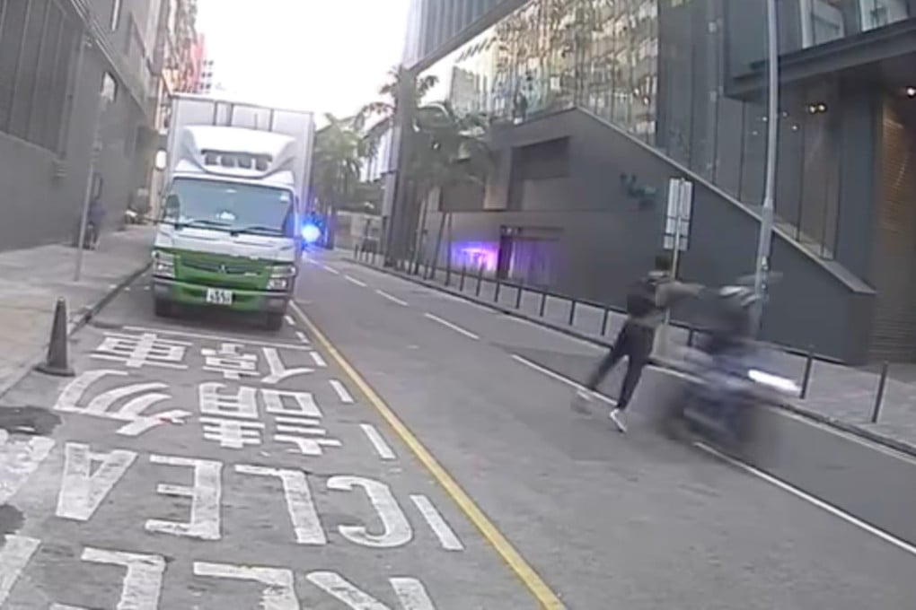 A man in grey is seen interfering in the path of an incoming motorcyclist. Photo: Facebook/Bosco Chu