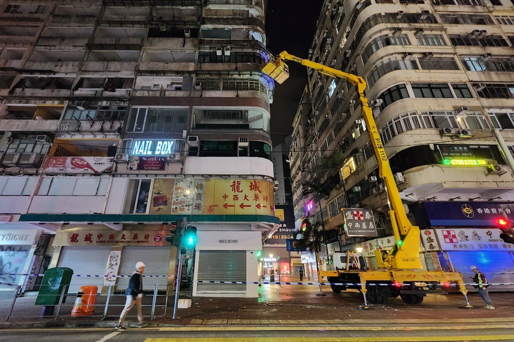 Contractors inspect the building at No 76 Percival Street in Causeway Bay. Photo: Harvey Kong