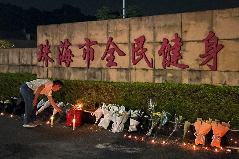 A man looks at candles left outside the Zhuhai Sports Centre on November 12, 2024, a day after a car rammed through the site killing dozens in Zhuhai. Photo: Amber Wang