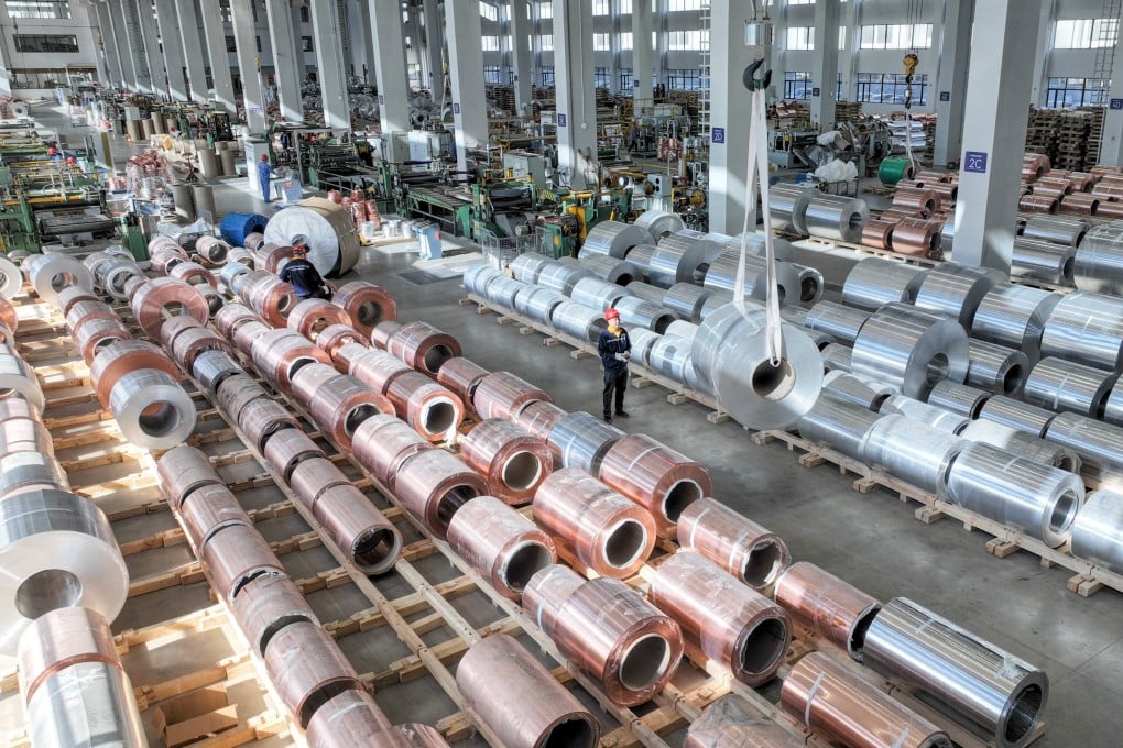 A worker produces high-performance copper-aluminium-foil materials for export at a materials workshop in China’s Zhejiang province. Photo: Getty Images