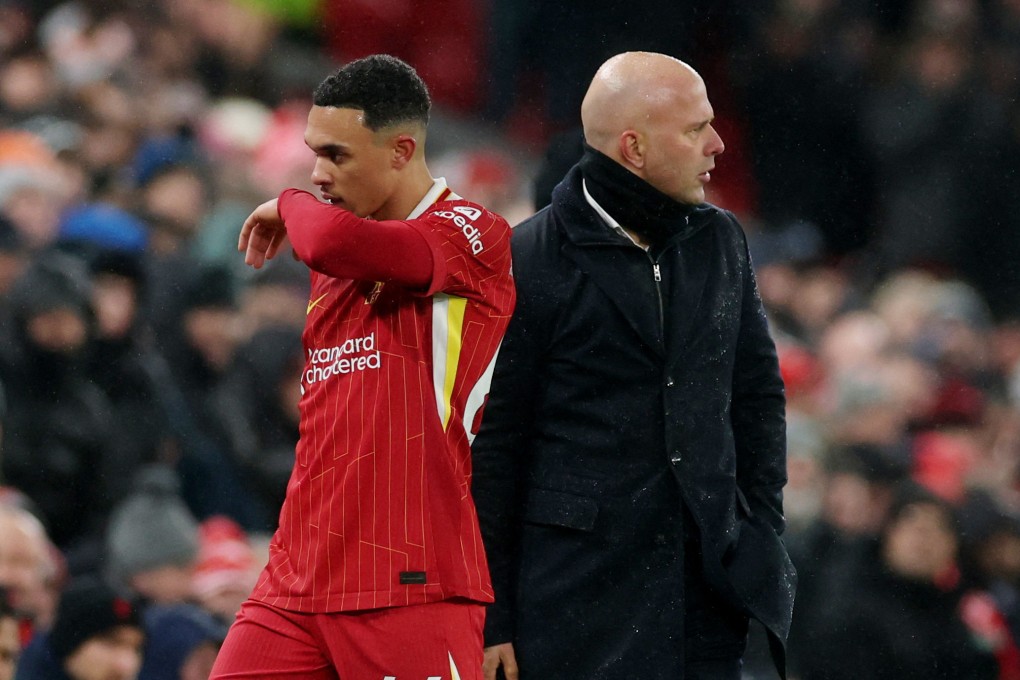 Liverpool defender Trent Alexander-Arnold walks off the pitch past manager Arne Slot after the draw with Manchester United. Photo: Reuters