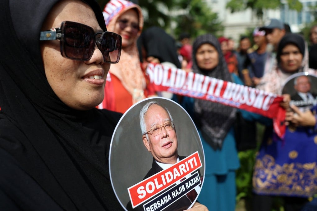 A supporter of Malaysia’s former prime minister Najib Razak takes part in a solidarity rally outside the Court of Appeal in Putrajaya on Monday. Photo: Reuters
