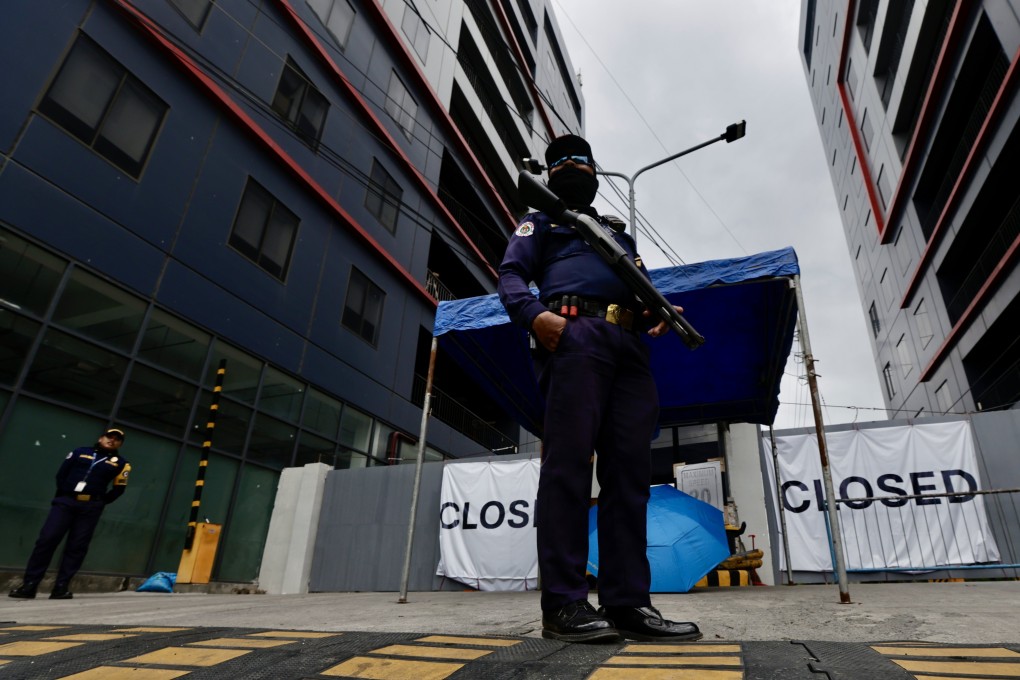 Security officers stand guard at the gates of a closed online gambling building, the largest Philippine Offshore Gaming Operators (Pogo) hub in the country, in the town of Kawit, Cavite province, the Philippines, on December 29, 2024. Photo: EPA-EFE
