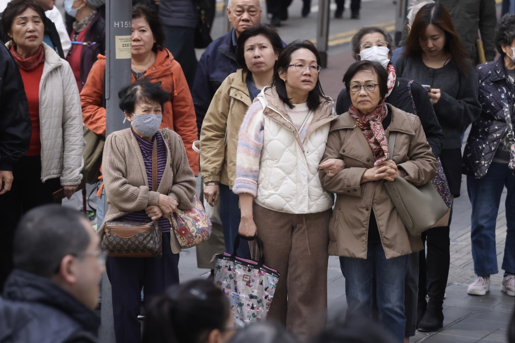 Residents in Causeway Bay dress warmly for the cold weather in mid-December. Photo: Jonathan Wong