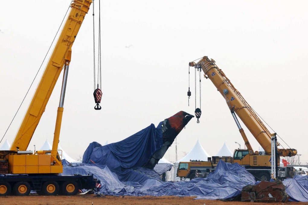 Tarpaulin shrouds the wreckage of the Jeju Air Boeing 737-800 aircraft, which on December 29 crashed and burst into flames at Muan International Airport. Photo: Yonhap/AFP