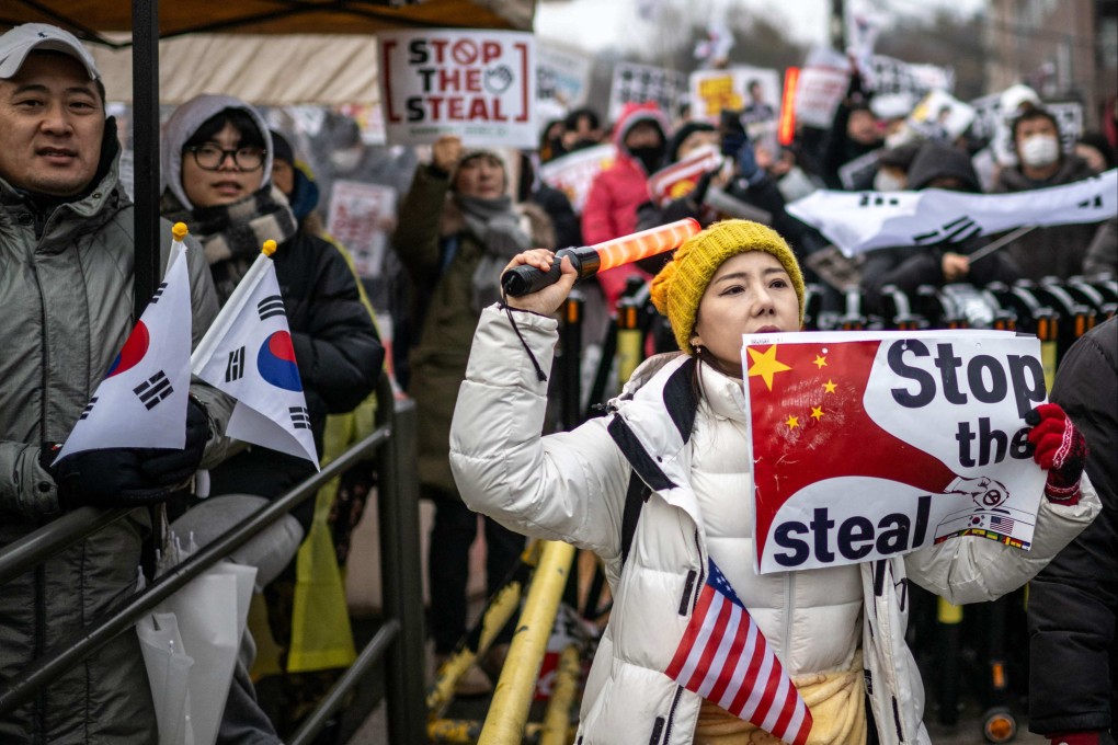 Supporters of South Korea’s impeached president Yoon Suk-yeol hold placards reading “Stop the steal” during a rally near his residence in Seoul on Sunday. Photo: AFP