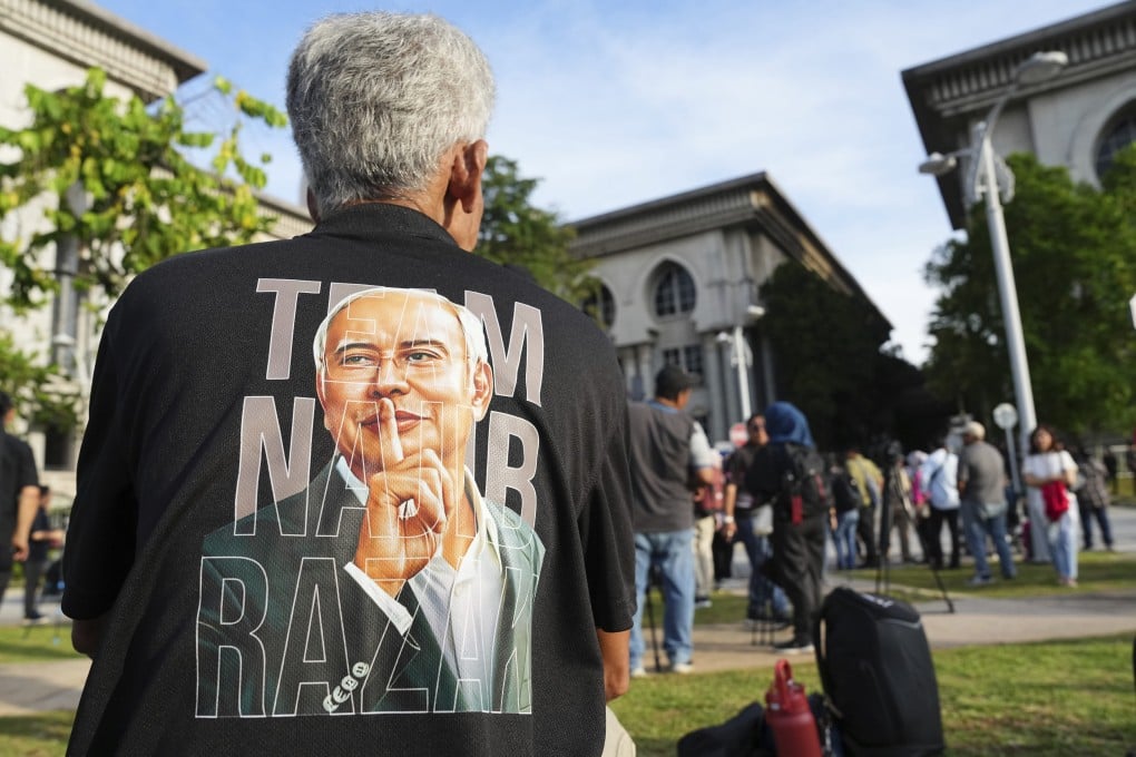 A supporter of former prime minister Najib Razak waits outside the Court of Appeal in Putrajaya, Malaysia, on Monday. Photo: AP
