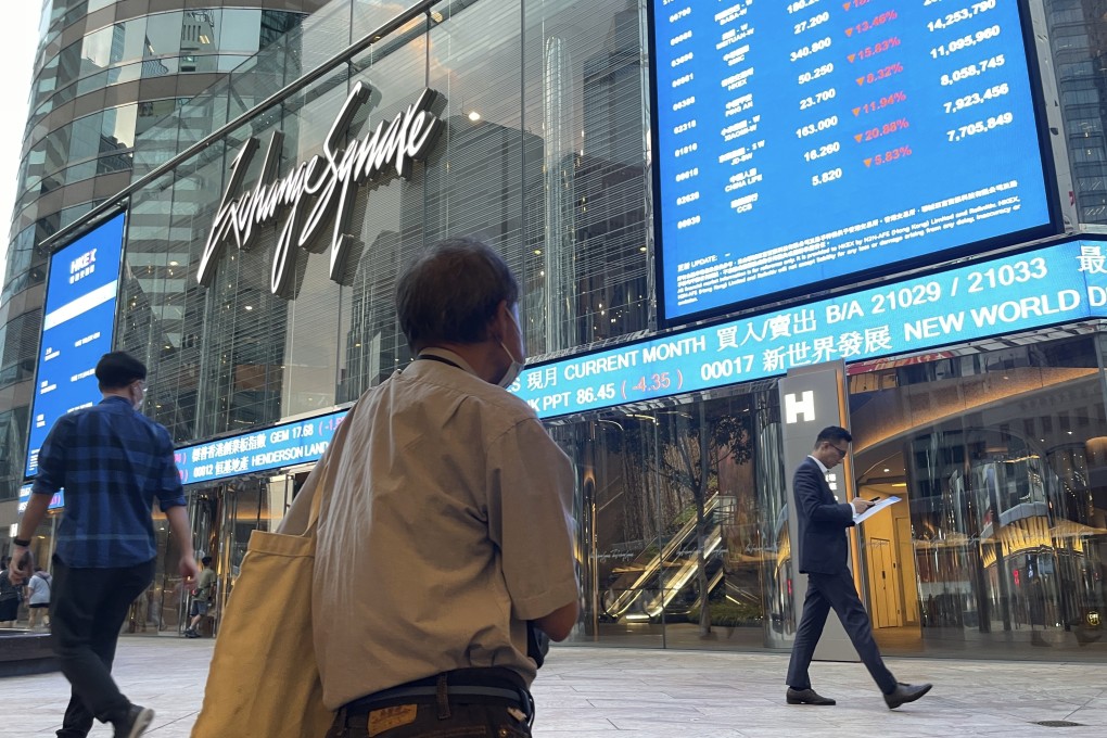 People walk past screens showing stock prices outside the Exchange Square in Central, Hong Kong in October 2024. AP Photo