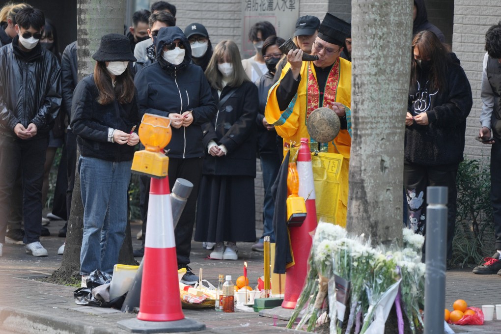 Family members and friends attend a roadside memorial for the motorcyclist who died last Friday in a crash while allegedly fleeing police. Photo: Sam Tsang