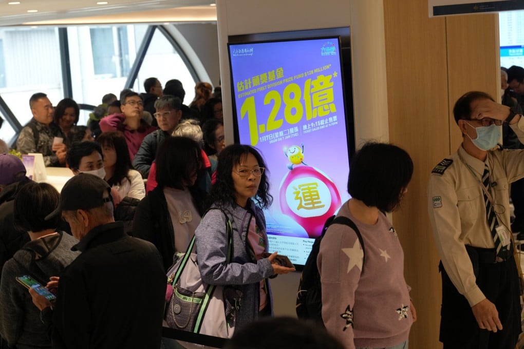 People queue up for Mark Six lottery tickets at a betting branch on Stanley Street in Central. Photo: Sam Tsang