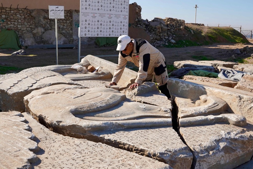 An archaeology expert catalogues destroyed artefacts - which range from bas-reliefs and sculptures to decorated slabs depicting mythical creatures - at the archaeological site of Nimrud, south of Mosul, Iraq, on January 3, 2025. Photo: AFP