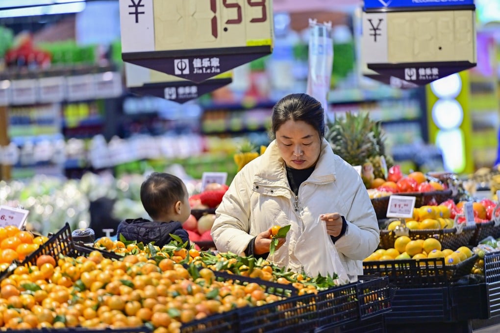A customer selects fruits at a supermarket in Qingzhou, Shandong province, last month. Photo: Xinhua