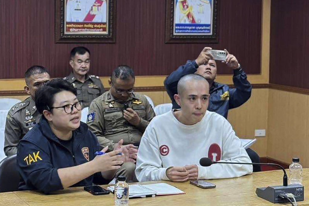 Chinese actor Wang Xing (right) speaks with Thai police officers in Mae Sot district, Thailand on Tuesday after being rescued from a scam compound in Myanmar. Photo: The Royal Thai Police via AP