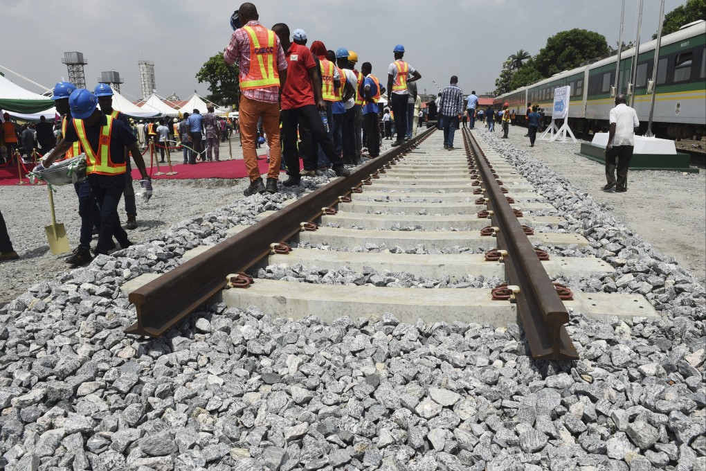 Workers from a Chinese construction group attend a ground breaking ceremony for the Lagos-Ibadan railway in Nigeria in 2017. The line is one of several rail projects China has funded in the country over recent years. Photo: AFP