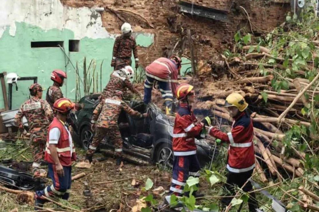 Rescuers remove the bodies of the victims from the car wreckage in Penang last September. Photo: Facebook/BombaMalaysiaOfficial