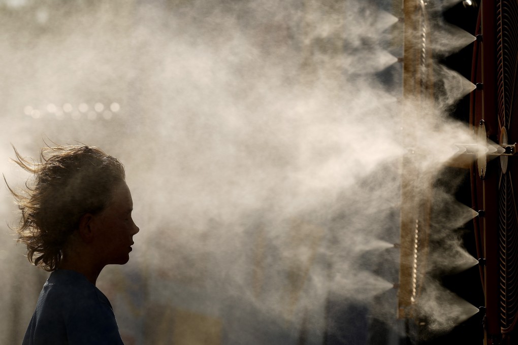 A boy cools off in a mister before a baseball game in Kansas City, Missouri in 2024. File photo: AP
