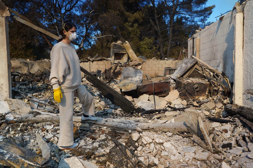 Nicole Perri looks for belongings in the ruins of her house destroyed by the fire in the Pacific Palisades neighbourhood of Los Angeles on January 10. Photo: AFP