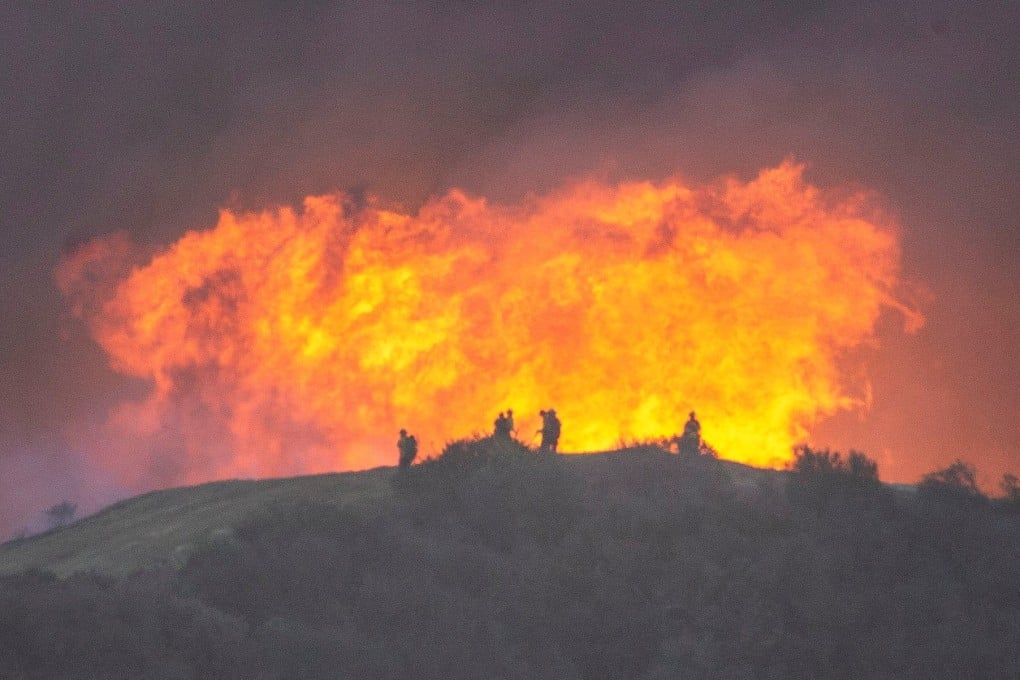 Firefighters battle the Palisades fire in California on Sturday. Photo: Reuters
