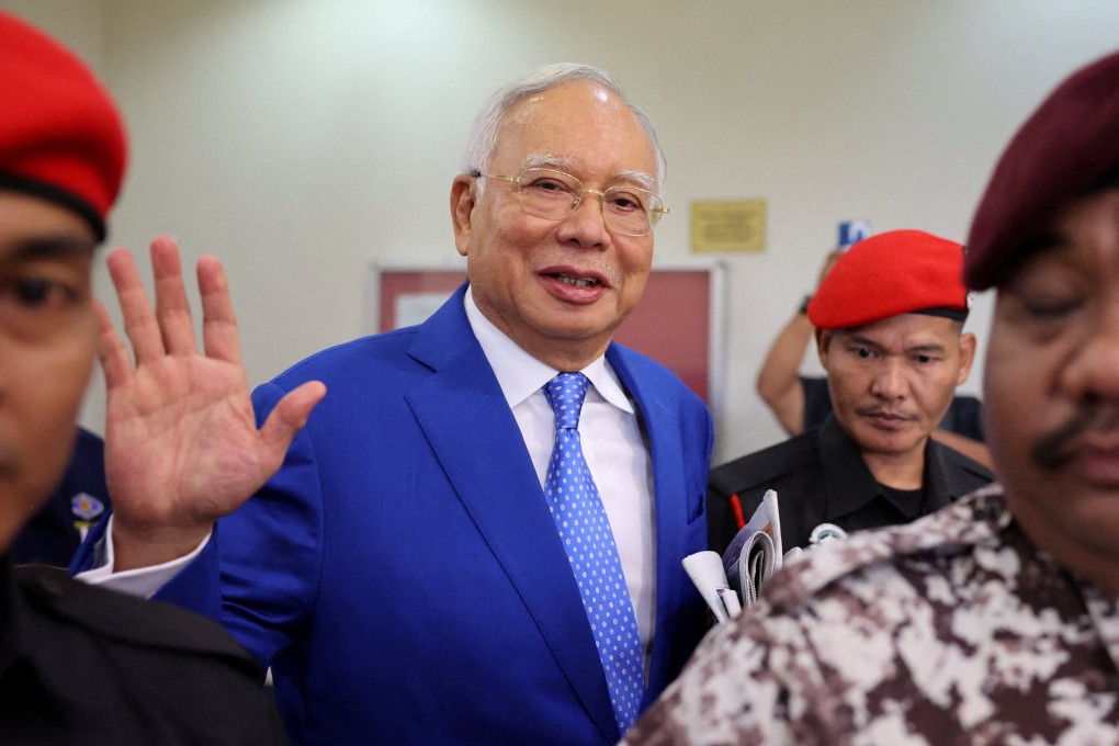 Former Malaysian prime minister Najib Razak waves as he is escorted after attending court proceedings in Kuala Lumpur on January 19, 2024. Photo: Reuters