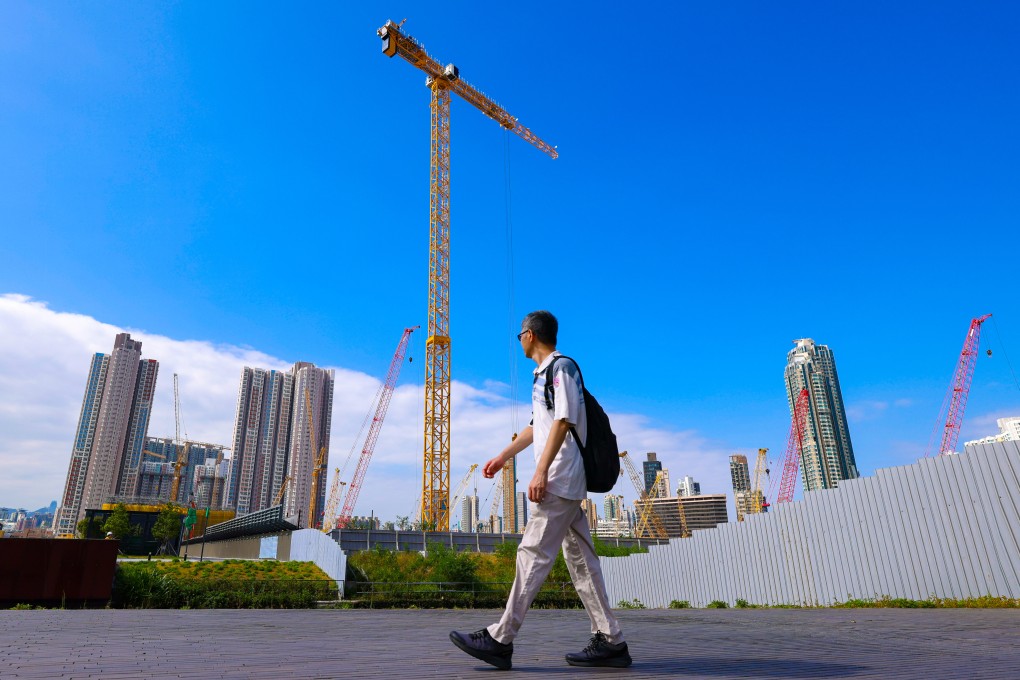 A man walked through Kai Tak with construction in the background. Photo: Nora Tam