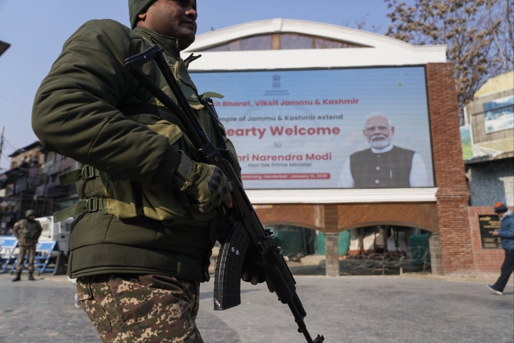 An Indian paramilitary soldier patrols near an electronic display in Srinagar welcoming Indian Prime Minister Narendra Modi to inaugurate a strategic tunnel project that connects Kashmir with Ladakh on Monday. Photo: AP