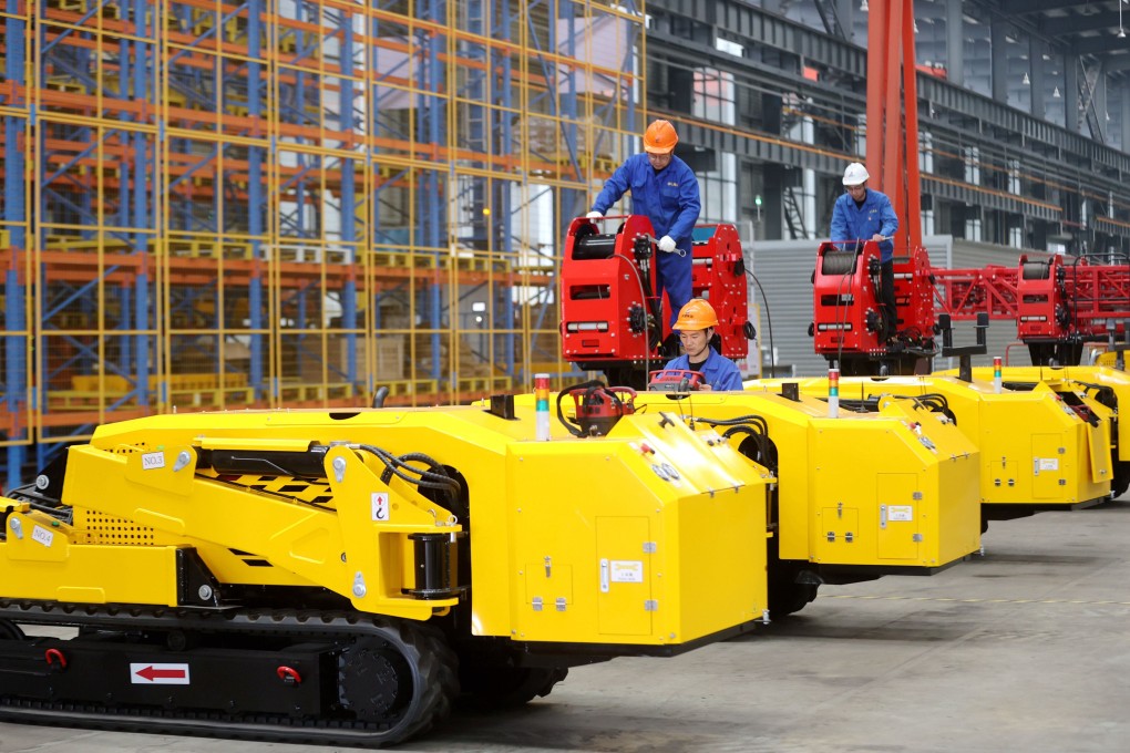 Workers assemble lightweight crawler-driven electrical tower building machines at a smart factory in China’s Zhejiang province last month. Photo: Xinhua