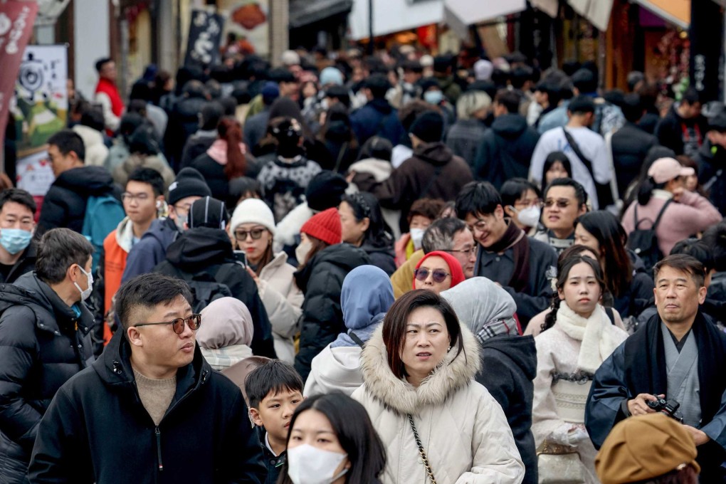 Tourists walk past shops and restaurants in Kyoto on Monday. Photo: AFP
