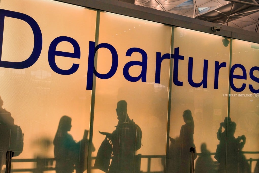 The shadows of travellers are projected on the wall of the departure hall in Hong Kong International Airport. Photo: Elson Li