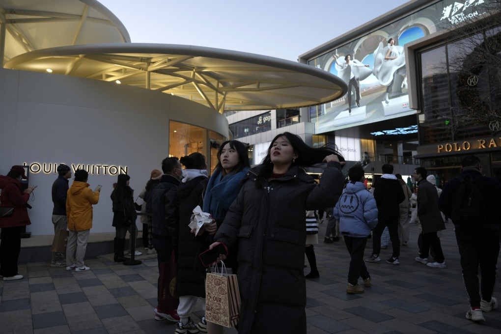 Shoppers visit a popular mall in Beijing last month. Photo: AP