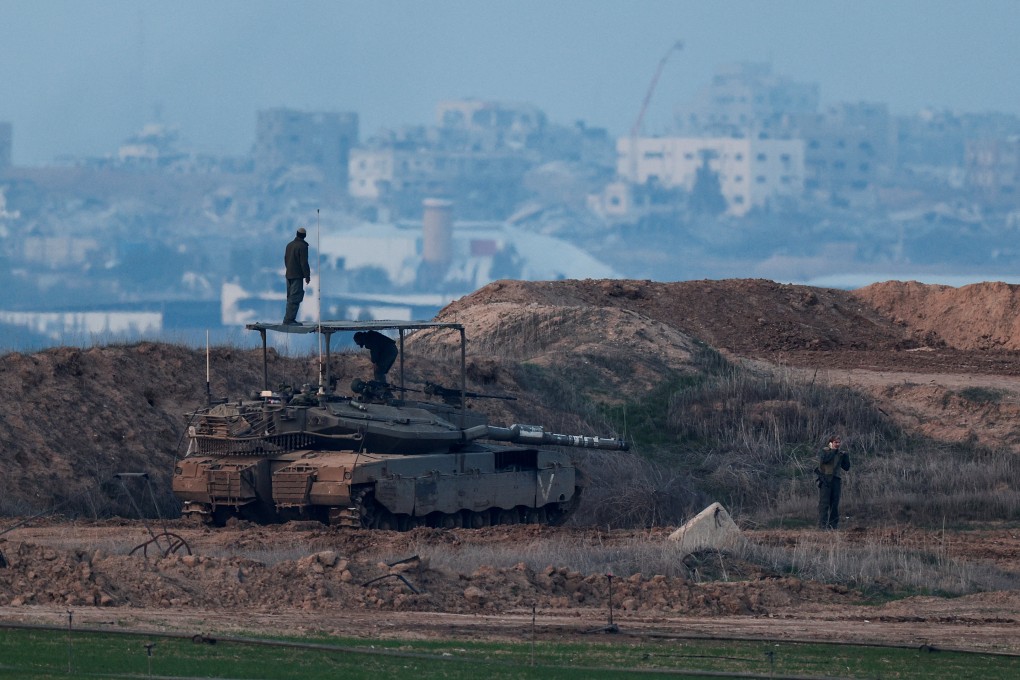 Israeli soldiers stand on a tank, as seen from the Israeli side of the border with Gaza. Photo: Reuters