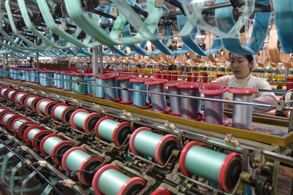 An employee works on a silk production line at a textile factory in Fuyang, in eastern China’s Anhui province on January 16, 2025. Photo: AFP