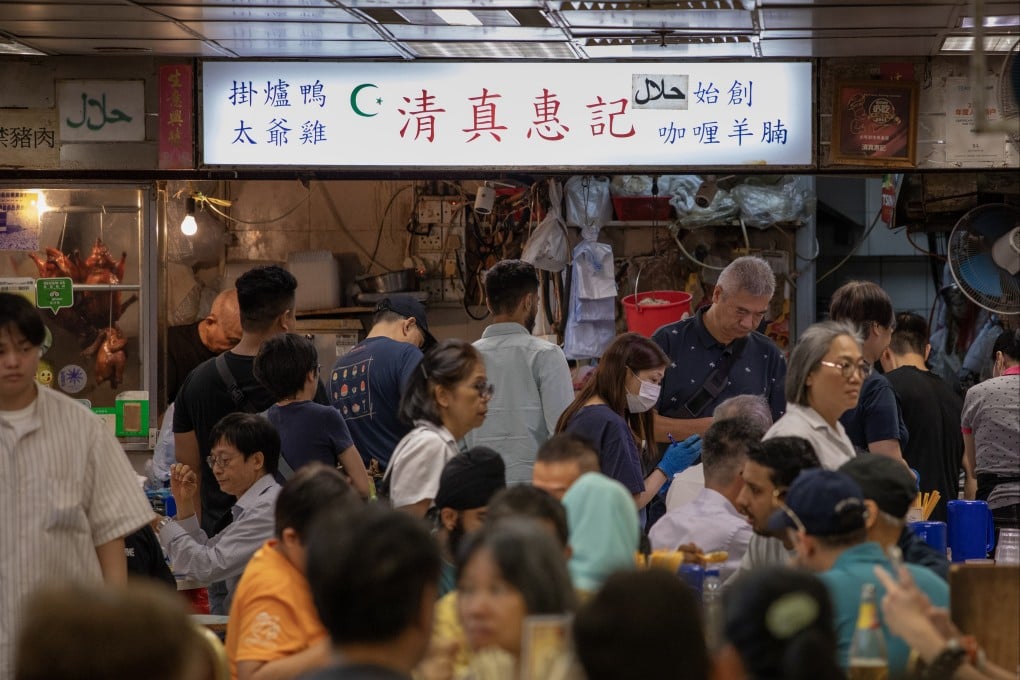 Customers sit and stand around a halal eatery in Bowrington Road Market, Wan Chai, on October 19. Photo: Antony Dickson