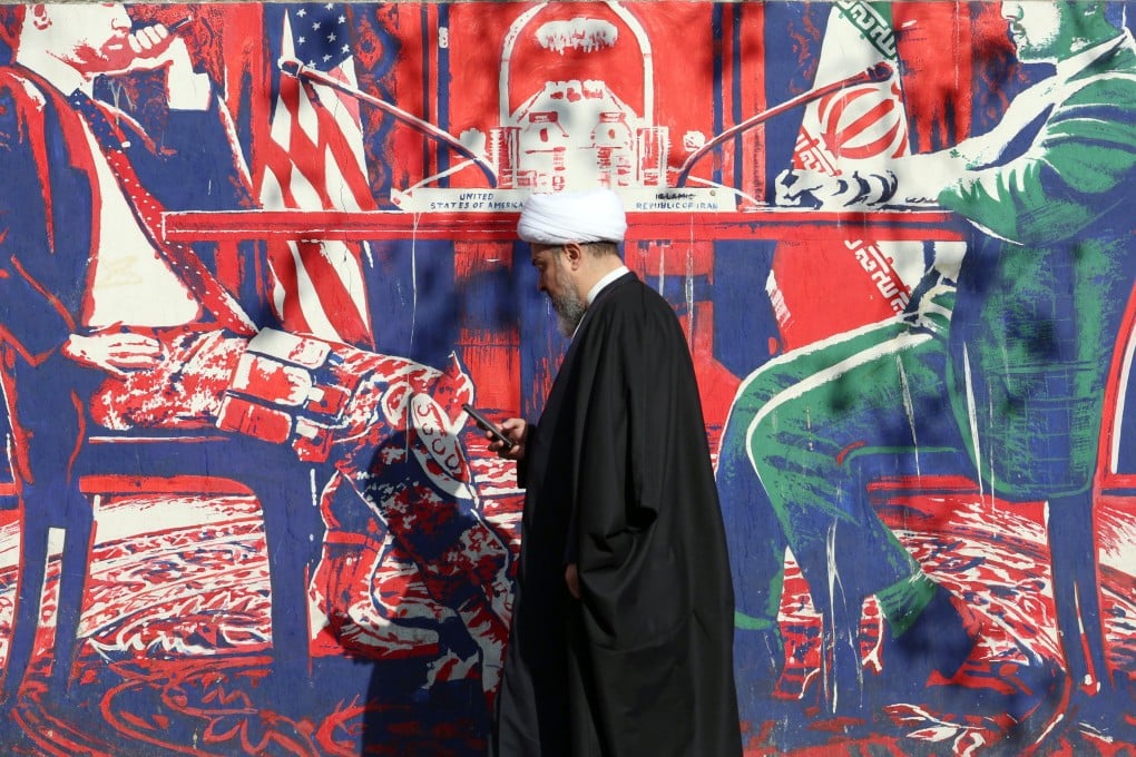 An Iranian cleric walks next to an anti-US mural in Tehran, Iran, on Wednesday. Photo: EPA-EFE