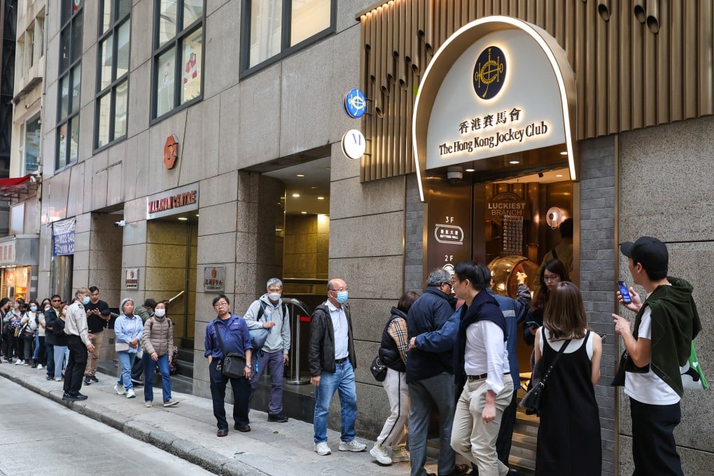 People queue up to buy lottery tickets at a betting branch of the Hong Kong Jockey Club in Central. Photo: Edmond So