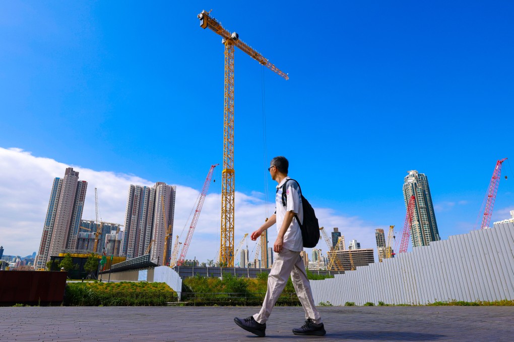 A man walks past construction in Kai Tak. Photo: Nora Tam