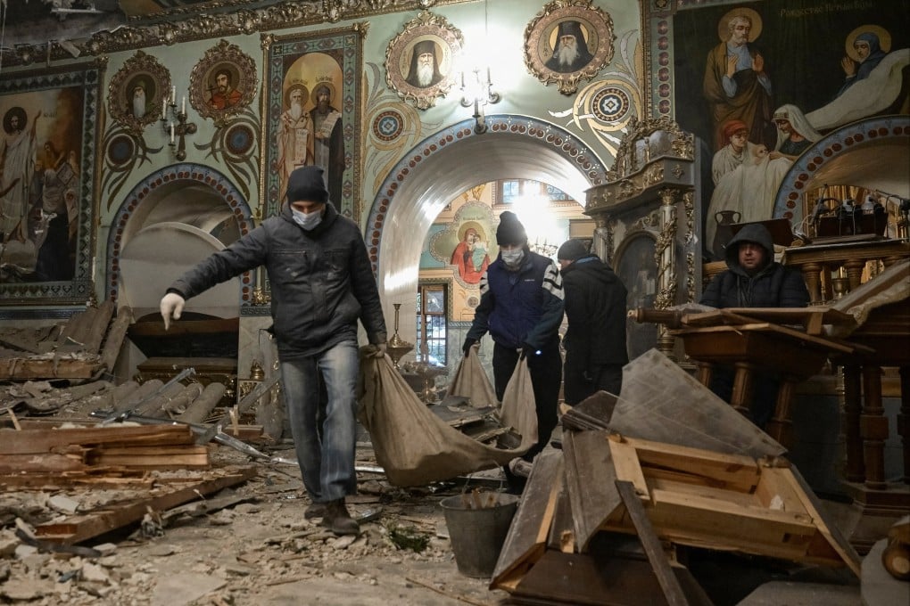 Priests and worshippers clear debris inside St Andrew’s Cathedral damaged by Russian missile strikes, in Zaporizhzhia, Ukraine. Photo: Reuters