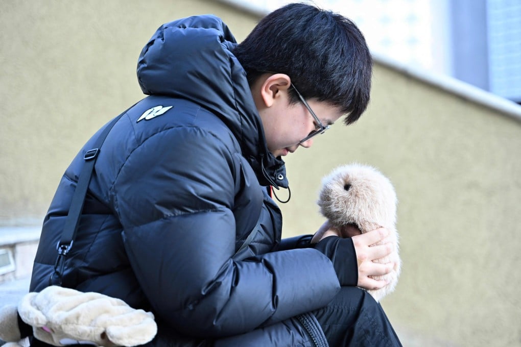 Beijing teenager Zhang Yachun with her AI-powered robot. The smart pet market is expected to grow sevenfold by 2033. Photo: AFP