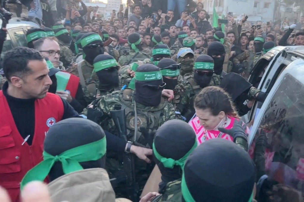 Palestinian Hamas militants hand over Doron Steinbrecher on Sunday. Photo: Reuters