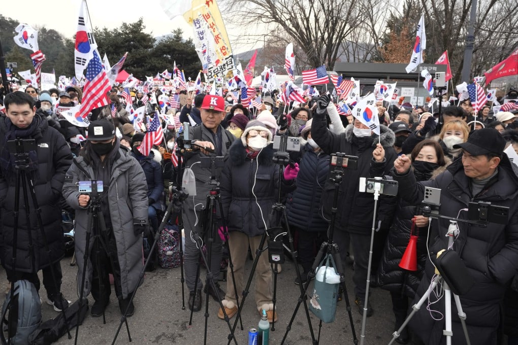 YouTubers supporting Yoon Suk-yeol, South Korea’s impeached president, hold a rally in Uiwang, South Korea, on Thursday. Photo: AP