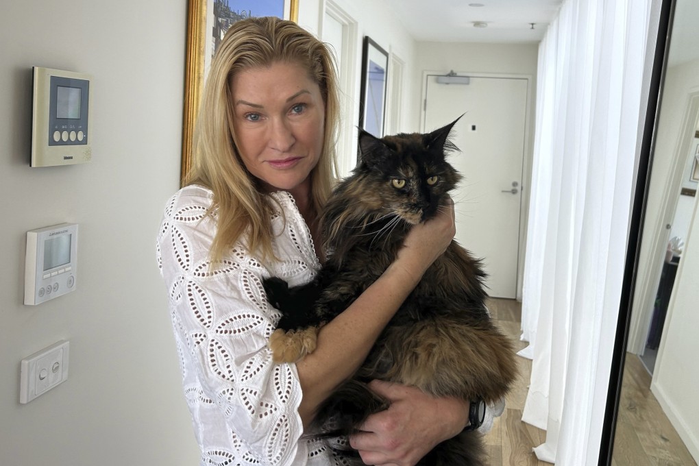 Margo Neas holds her cat Mittens at her home in Melbourne, Australia, on Wednesday. Photo: AP