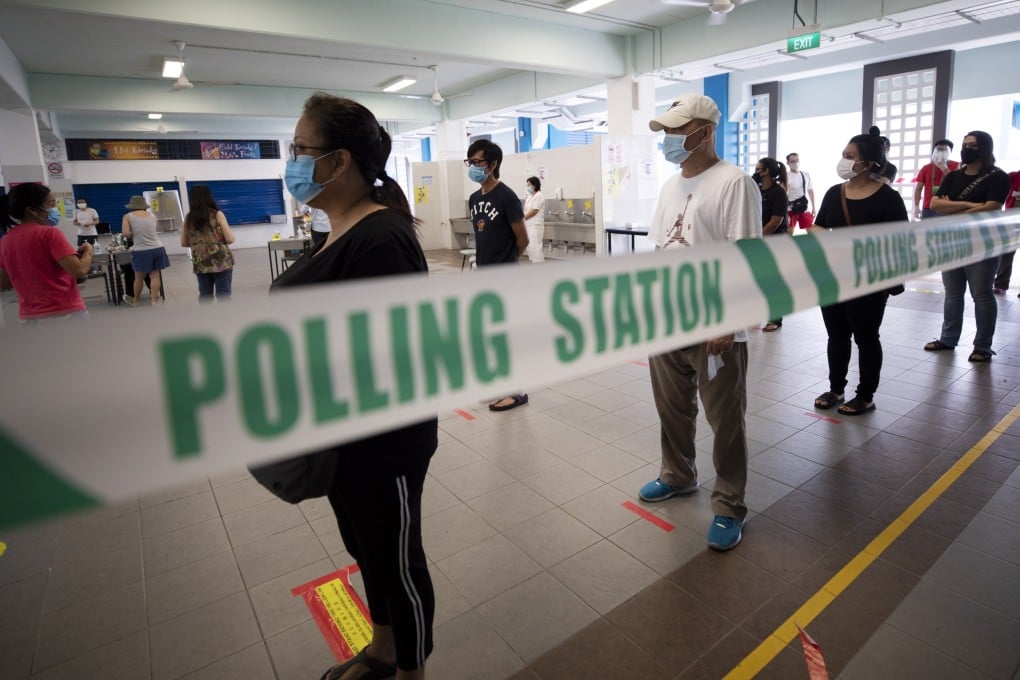 Voters in Singapore queue to cast their ballots at a polling station during the general election on July 10, 2020. Photo: EPA-EFE