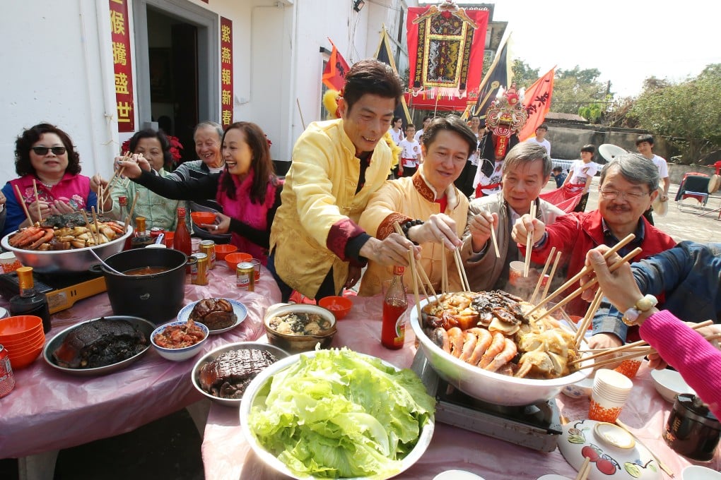 Residents of Ng Ka Tsuen, in Yuen Long, Hong Kong, enjoy a Lunar New Year poon choi meal. Photo: David Wong